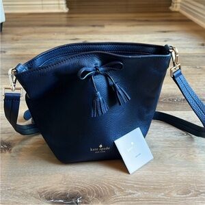 Kate Spade mini bucket bag. Never used. Missing tags but has care card.